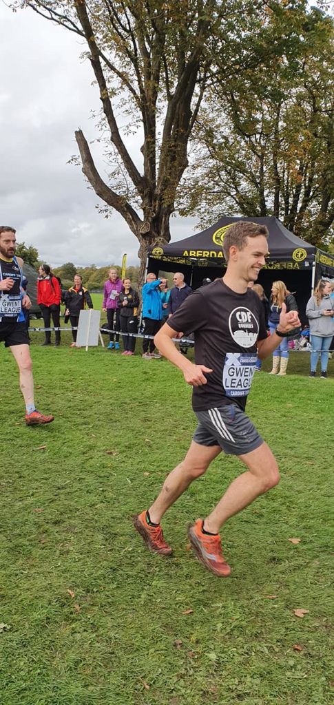 Sam approaching the end of a lap with a big grin on his face