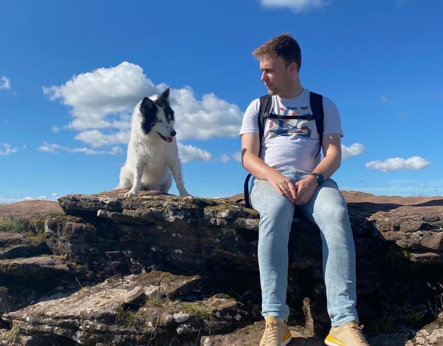 George sitting on a rocky outcrop looking over to his gorgeous white collie who is admiring the views.