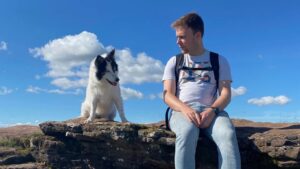 George sitting on a rocky outcrop looking over to his gorgeous white collie who is admiring the views.